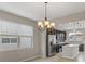 Bright dining area with elegant lighting and a view into the modern kitchen at 2682 Mead Ave, St Cloud, FL 34771