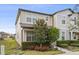 Charming two-story townhouse features well-maintained landscaping, including neatly trimmed hedges and vibrant flowering plants at 2682 Mead Ave, St Cloud, FL 34771