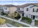 Inviting two-story townhome with manicured front lawn and sidewalk leading to the front door at 2682 Mead Ave, St Cloud, FL 34771