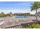 Inviting community pool with ample lounge chairs, palm trees, and a well-maintained deck at 2682 Mead Ave, St Cloud, FL 34771
