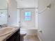 Bright bathroom featuring a shower-tub combination with tile surround and a granite-topped vanity sink at 2863 Harlow Ave, St Cloud, FL 34772