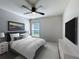 Bedroom with ceiling fan, TV, and window with blinds; bed and dressers present at 2863 Harlow Ave, St Cloud, FL 34772