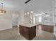 Open kitchen with an island, modern lighting and views of the rest of the house at 2875 Stanfield Ave, Orlando, FL 32814