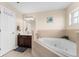 Bathroom featuring jacuzzi tub, brown vanity and ceramic tile floors at 302 Vista Loop, Davenport, FL 33897