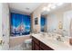 Charming bathroom with a double sink vanity, neutral tones, and a tub with shower at 302 Vista Loop, Davenport, FL 33897