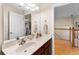 Bright bathroom featuring double sinks, a large mirror, and modern fixtures at 302 Vista Loop, Davenport, FL 33897