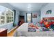 Inviting bedroom with ample natural light, wood floors, and a comfortable bed at 302 Vista Loop, Davenport, FL 33897
