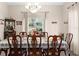 Formal dining room with elegant chandelier, large window, and seating for eight at 302 Vista Loop, Davenport, FL 33897