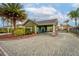 Gated community entrance with lush landscaping and well-maintained grounds for secure living at 302 Vista Loop, Davenport, FL 33897