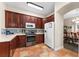 Bright kitchen boasts dark wood cabinets, stainless steel appliances, and decorative tile backsplash at 302 Vista Loop, Davenport, FL 33897
