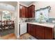 Stylish kitchen offers stainless steel appliances, dark cabinets, and a view into the dining room at 302 Vista Loop, Davenport, FL 33897