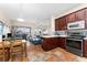 Well-lit kitchen features a breakfast bar, stainless steel appliances, and decorative tile flooring at 302 Vista Loop, Davenport, FL 33897