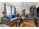 Cozy living room with a large window, comfortable sofa, and hardwood floors at 302 Vista Loop, Davenport, FL 33897