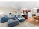 Open-concept living room with barstool seating and bright kitchen at 302 Vista Loop, Davenport, FL 33897