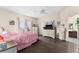 Comfortable main bedroom boasts wood flooring, a ceiling fan, and a view of the backyard at 302 Vista Loop, Davenport, FL 33897