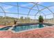 Screened-in pool with a brick patio, a spa, and lounge chairs for relaxation and enjoyment at 302 Vista Loop, Davenport, FL 33897