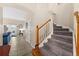 A staircase leading up to the second floor features wood handrail, carpeted steps and tile flooring at 302 Vista Loop, Davenport, FL 33897