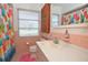 Cozy pink bathroom features a vanity and shower with a beach-themed curtain at 3045 Cecelia Dr, Apopka, FL 32703