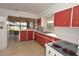 Retro kitchen featuring bright red cabinets and a scenic lake view at 3045 Cecelia Dr, Apopka, FL 32703