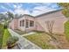 Quaint home featuring a lush green lawn, decorative shrubs, and a gray stone pathway at 335 Beloit Ave, Winter Park, FL 32789