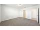 Well-lit bedroom featuring neutral carpet, white walls, and a closet for storage at 3797 Giorgio Dr, Winter Haven, FL 33884