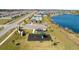 Aerial view of a community with a pool, playground, lake, and residential homes in a suburban setting at 3845 Giorgio Dr, Winter Haven, FL 33884