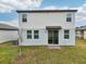 Home backyard with sliding glass door, grassy area and AC unit, perfect for outdoor activities at 3845 Giorgio Dr, Winter Haven, FL 33884