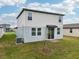 Home backyard with sliding glass door, grassy area and AC unit, perfect for outdoor activities at 3845 Giorgio Dr, Winter Haven, FL 33884