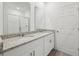 Stylish bathroom featuring double sinks with granite countertops, a glass shower, and bright lighting at 3845 Giorgio Dr, Winter Haven, FL 33884