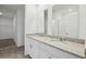 Modern bathroom featuring double sinks with granite countertops and a glass-enclosed shower, exuding elegance and comfort at 3845 Giorgio Dr, Winter Haven, FL 33884