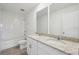 Well-lit bathroom with double sink vanity with granite countertops and tile flooring at 3845 Giorgio Dr, Winter Haven, FL 33884
