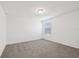 Simply designed bedroom with plush carpeting and a window bringing in natural light at 3845 Giorgio Dr, Winter Haven, FL 33884