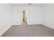 Clean, carpeted bedroom with an open doorway, offering a blank canvas for creating a comfortable retreat at 3845 Giorgio Dr, Winter Haven, FL 33884