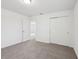 Bright bedroom with plush carpeting, closet with sliding doors, and simple interior design at 3845 Giorgio Dr, Winter Haven, FL 33884