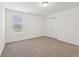 Bright bedroom featuring a plush carpet, a window with blinds, and a neutral color palette at 3845 Giorgio Dr, Winter Haven, FL 33884