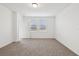 Bright bedroom with carpet, two windows with blinds, and a doorway, perfect for relaxation and rest at 3845 Giorgio Dr, Winter Haven, FL 33884