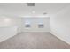 Bright bonus room featuring plush carpeting and two windows that illuminate the open space at 3845 Giorgio Dr, Winter Haven, FL 33884