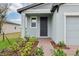 Inviting front entrance with brick pathway, manicured landscaping and a covered porch at 3845 Giorgio Dr, Winter Haven, FL 33884