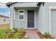 Inviting front entrance with brick pathway, manicured landscaping and a covered porch at 3845 Giorgio Dr, Winter Haven, FL 33884