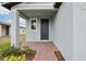 Inviting front entrance with brick pathway, manicured landscaping and a covered porch at 3845 Giorgio Dr, Winter Haven, FL 33884