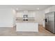 Modern kitchen island with stainless steel appliances, granite countertops, and ample cabinet space at 3845 Giorgio Dr, Winter Haven, FL 33884