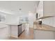 Open kitchen featuring an island, stainless steel appliances, granite countertops, and tile flooring at 3845 Giorgio Dr, Winter Haven, FL 33884
