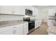 Modern kitchen featuring stainless steel appliances, granite countertops, and white cabinets at 3845 Giorgio Dr, Winter Haven, FL 33884