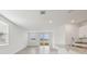Open-concept living area with tile floors, recessed lighting, and a sliding glass door to the outdoors at 3845 Giorgio Dr, Winter Haven, FL 33884