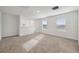 Bright loft area features neutral carpet, white walls, and lots of natural light from the windows at 3845 Giorgio Dr, Winter Haven, FL 33884
