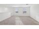 Bright loft area features neutral carpet, white walls, and lots of natural light from the windows at 3845 Giorgio Dr, Winter Haven, FL 33884