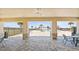 Covered patio area with stone pillars overlooking the community pool with tables and chairs for relaxing at 3845 Giorgio Dr, Winter Haven, FL 33884