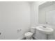 Clean powder room with a pedestal sink, toilet, and neutral-toned walls and flooring at 3845 Giorgio Dr, Winter Haven, FL 33884