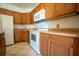 Functional kitchen featuring wood cabinets and white appliances at 3901 Bowfin Trail, Kissimmee, FL 34746