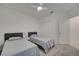 Simple bedroom with white walls, carpet, ceiling fan, closet, and two twin beds at 4057 Sagefield Dr, Harmony, FL 34773